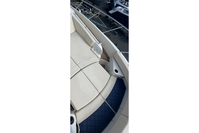 Slide: The Image of 2016 Chris-Craft Launch 36 boat interior with beige seating and blue flooring. - 45