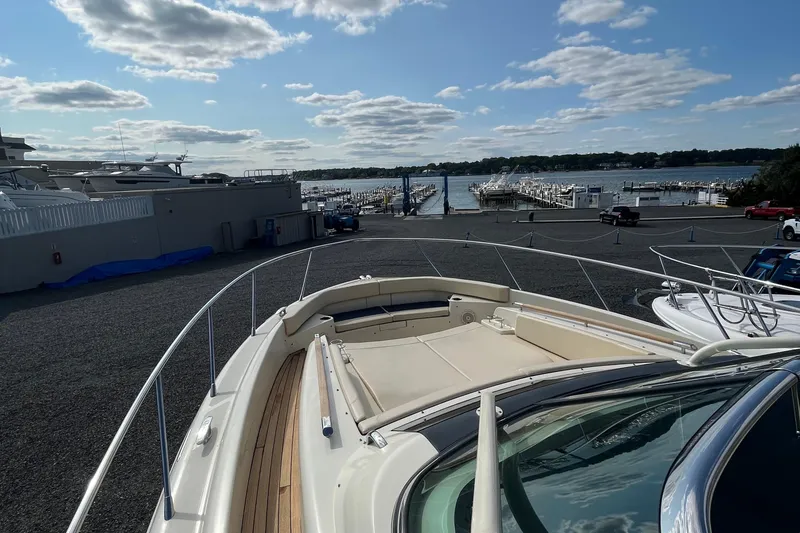 Slide: The Image of 2016 Chris-Craft Launch 36 yacht docked at a marina under a partly cloudy sky. - 51