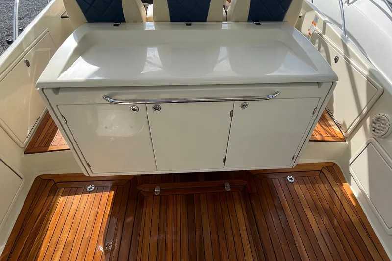 Slide: The Image of 2016 Chris-Craft Launch 36 interior with wooden flooring and storage cabinet. - 52