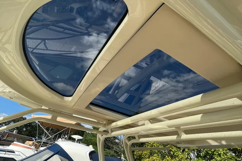 Slide: The Image of 2016 Chris-Craft Launch 36 boat with sunroof and clear blue sky reflection. - 64