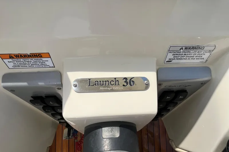 Slide: The Image of 2016 Chris-Craft Launch 36 control panel with warning labels and model plaque. - 69