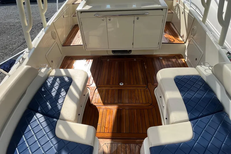 Slide: The Image of 2016 Chris-Craft Launch 36 interior with blue seating and polished wood flooring. - 74