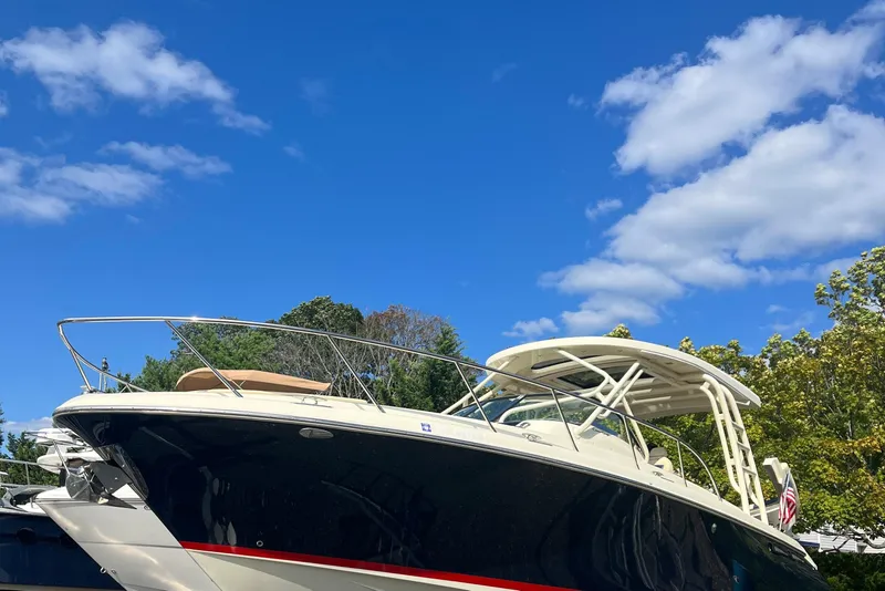Slide: The Image of 2016 Chris-Craft Launch 36 boat under clear blue sky with trees in background. - 76