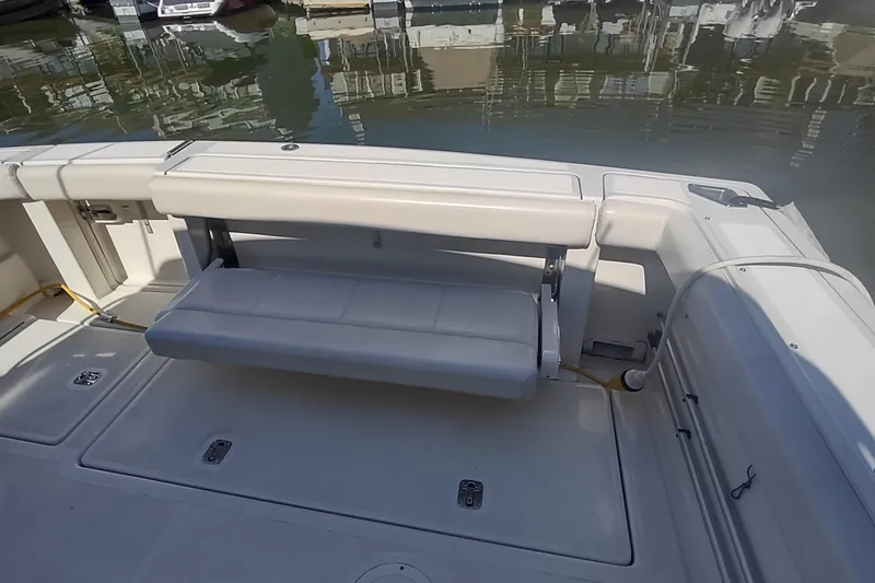 Slide: The Image of 1996 Tiara Yachts 3100 Open boat interior with foldable seating and dock view. - 10