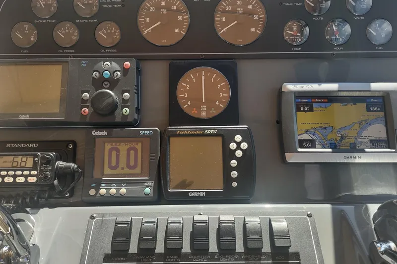 Slide: The Image of Dashboard of a 1996 Tiara Yachts 3100 Open with navigation and control instruments. - 16