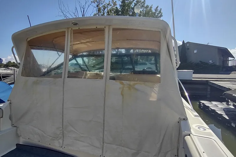 Slide: The Image of 1996 Tiara Yachts 3100 Open with canvas cover at dockside. - 19