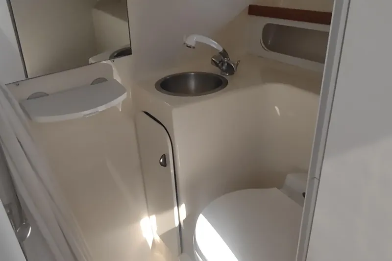 Slide: The Image of 1996 Tiara Yachts 3100 Open bathroom with sink and toilet. - 24