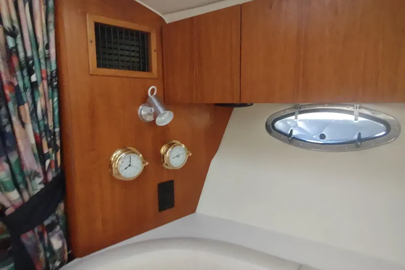 Slide: The Image of Interior of 1996 Tiara Yachts 3100 Open with wood paneling and nautical instruments. - 27
