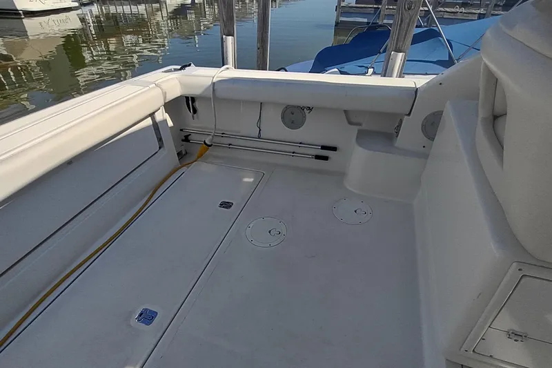 Slide: The Image of 1996 Tiara Yachts 3100 Open boat deck, featuring spacious seating and storage areas. - 3