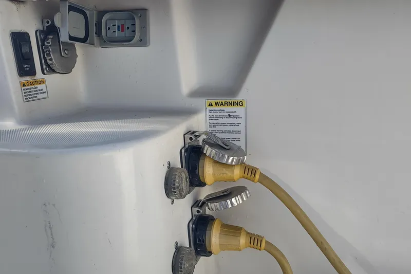 Slide: The Image of Electrical connections and warning labels on a 1996 Tiara Yachts 3100 Open. - 30