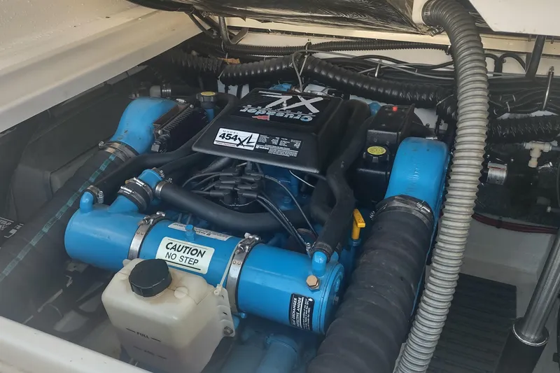 Slide: The Image of Engine compartment of a 1996 Tiara Yachts 3100 Open, featuring a blue marine engine. - 37