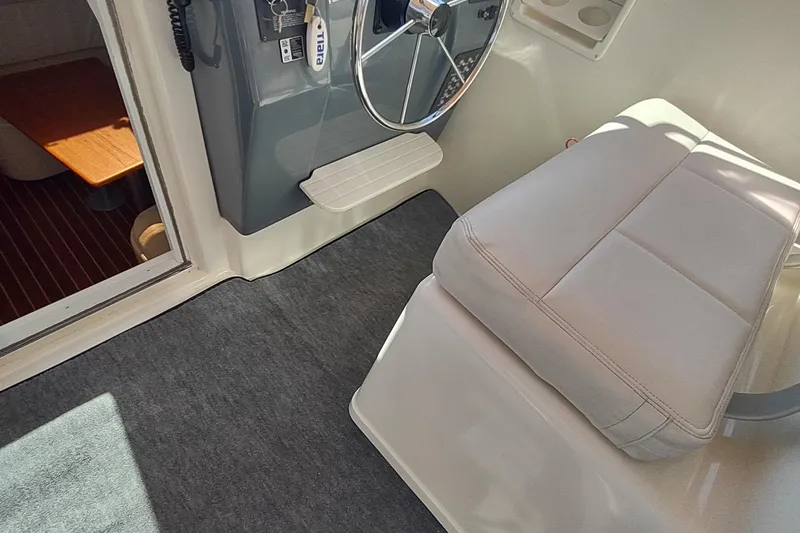 Slide: The Image of 1996 Tiara Yachts 3100 Open helm with cushioned seat and steering wheel. - 44