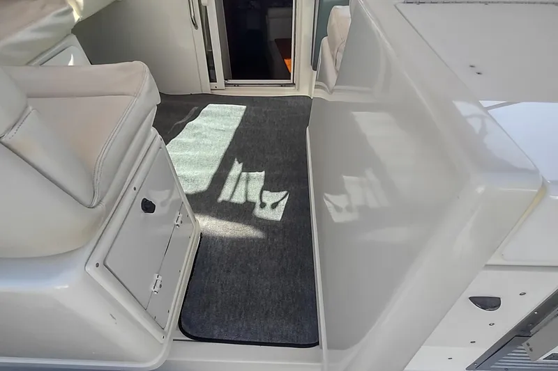 Slide: The Image of Interior view of a 1996 Tiara Yachts 3100 Open, featuring seating and cabin entrance. - 45