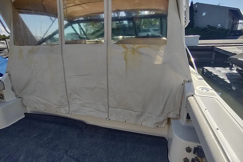 Slide: The Image of 1996 Tiara Yachts 3100 Open with covered cockpit area, docked at marina. - 46