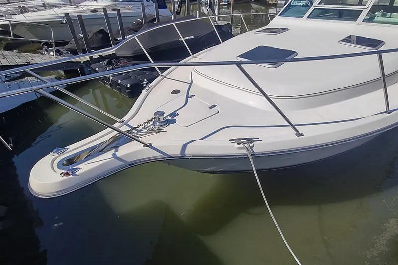 Slide: The Image of 1996 Tiara Yachts 3100 Open docked, showcasing sleek design and sturdy build. - 47