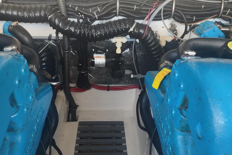 Slide: The Image of Engine compartment of a 1996 Tiara Yachts 3100 Open, showcasing blue engine components. - 6