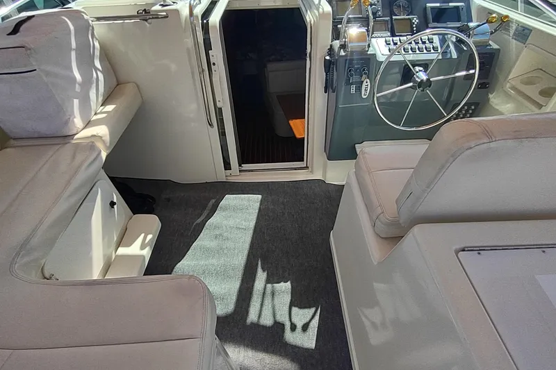 Slide: The Image of 1996 Tiara Yachts 3100 Open interior with helm, seating, and cabin entrance. - 7