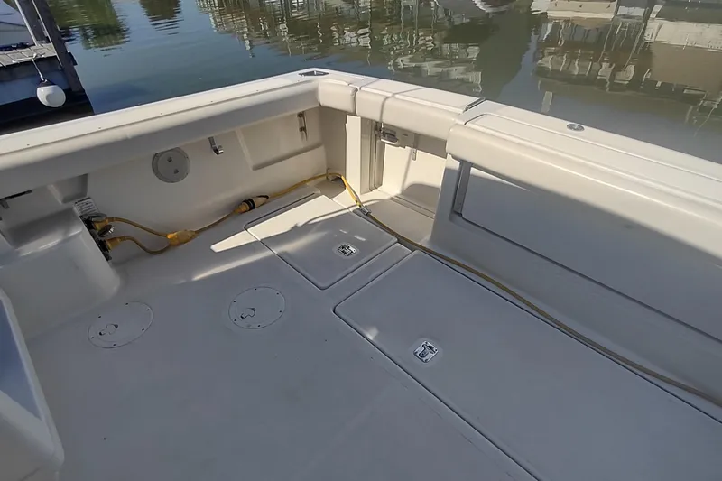 Slide: The Image of 1996 Tiara Yachts 3100 Open boat deck with storage compartments and cables. - 9