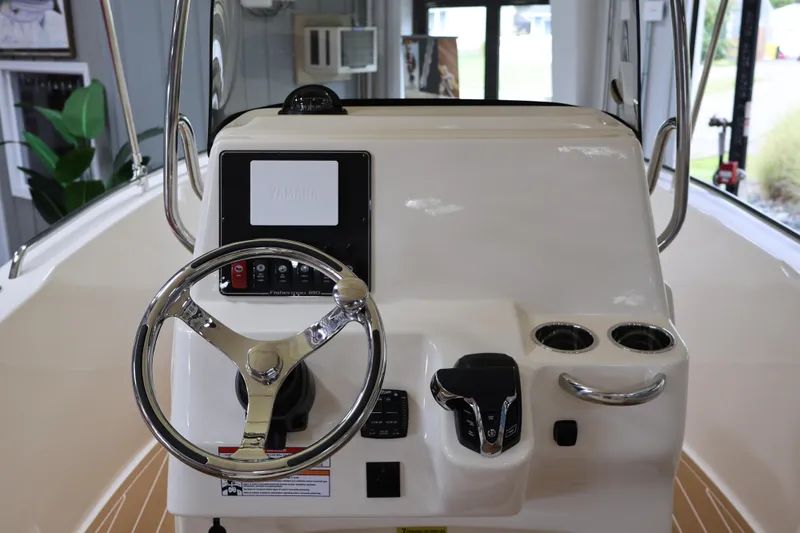 Slide: The Image of 2026 Grady-White Fisherman 180 boat console with steering wheel and controls. - 5
