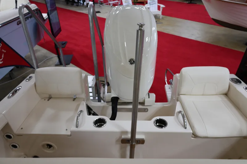 Slide: The Image of 2026 Grady-White Fisherman 180 boat interior with seating and motor, displayed on red carpet. - 6
