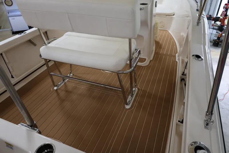 Slide: The Image of 2026 Grady-White Fisherman 180 boat interior with white seating and brown deck flooring. - 8