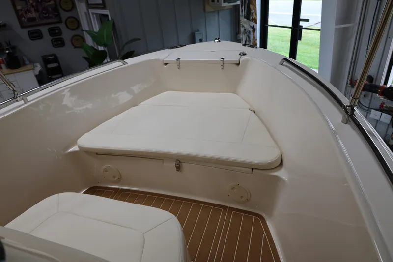 Slide: The Image of 2026 Grady-White Fisherman 180 boat interior with cushioned seating and wooden flooring. - 9