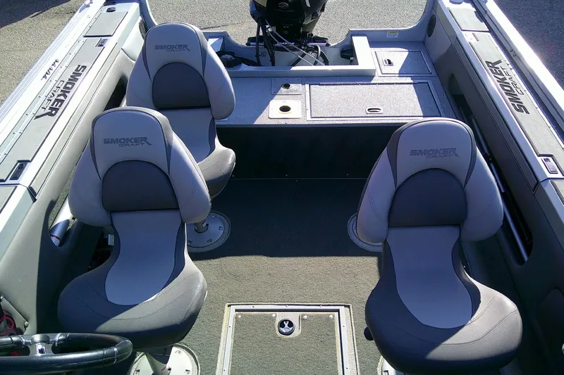 Slide: The Image of 2022 SMOKERCRAFT 182 Pro Angler XL boat interior with two gray seats and storage compartments. - 11
