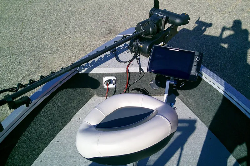 Slide: The Image of 2022 SMOKERCRAFT 182 Pro Angler XL boat interior with seat, trolling motor, and fish finder. - 14