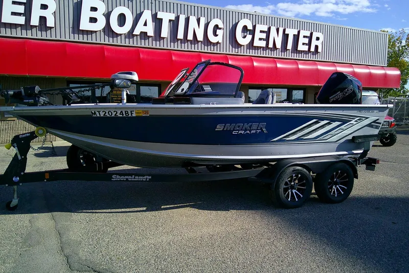 Slide: The Image of 2022 SMOKERCRAFT 182 Pro Angler XL boat on trailer outside boating center. - 2
