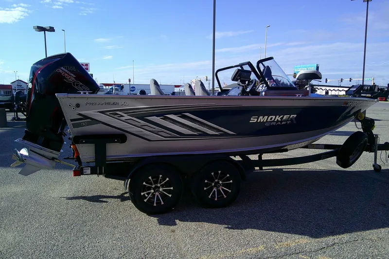 Slide: The Image of 2022 SMOKERCRAFT 182 Pro Angler XL boat on trailer in parking lot. - 4