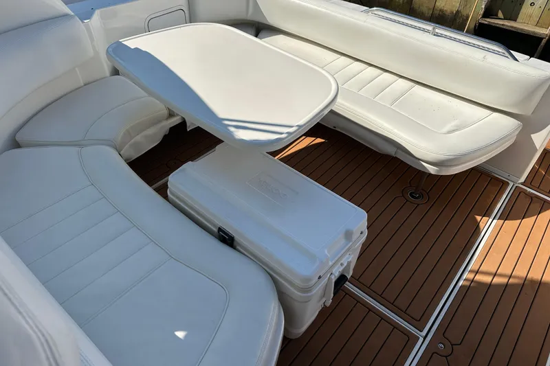Slide: The Image of Interior of 2000 Sea Ray 310 Sundancer with white seating and wooden flooring. - 12