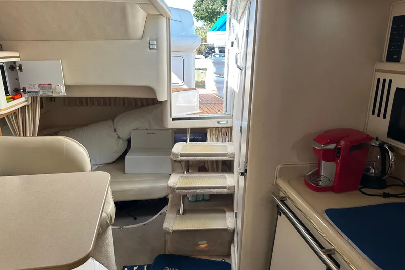 Slide: The Image of Interior of 2000 Sea Ray 310 Sundancer with cozy cabin and kitchenette. - 17