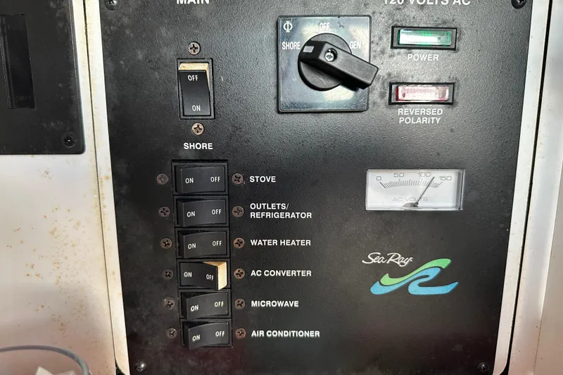 Slide: The Image of Electrical control panel of a 2000 Sea Ray 310 Sundancer boat, featuring various switches and indicators. - 22
