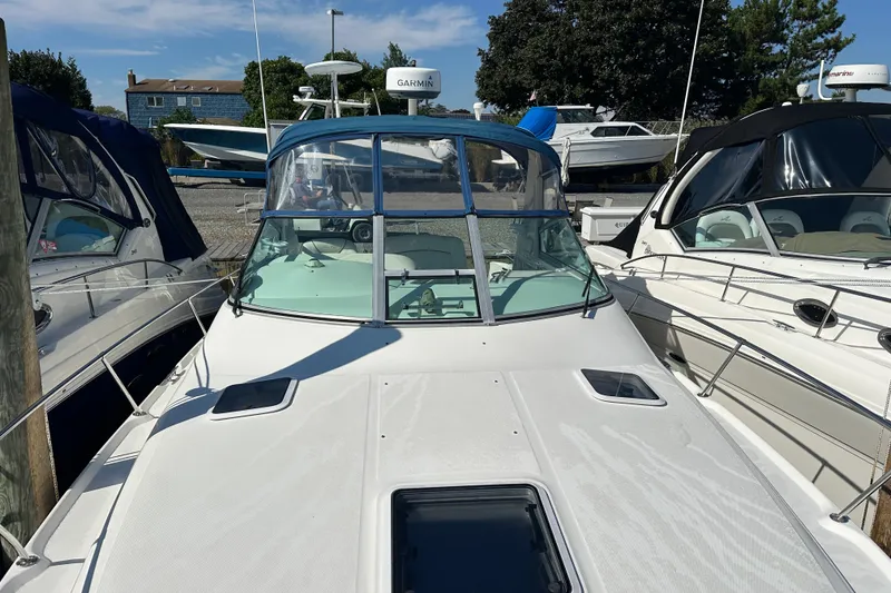 Slide: The Image of 2000 Sea Ray 310 Sundancer boat docked with clear windshield and Garmin equipment. - 6