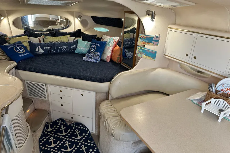 Slide: The Image of Interior of 2000 Sea Ray 310 Sundancer with cozy seating and nautical decor. - 9