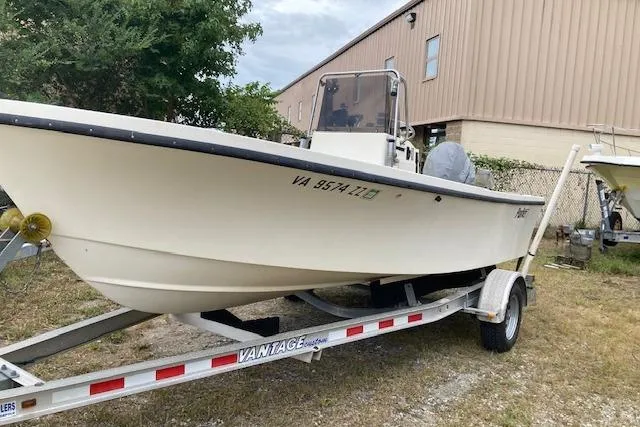 Slide: The Image of 1991 Parker 1801 Center Console boat on trailer, parked outdoors near a building. - 0