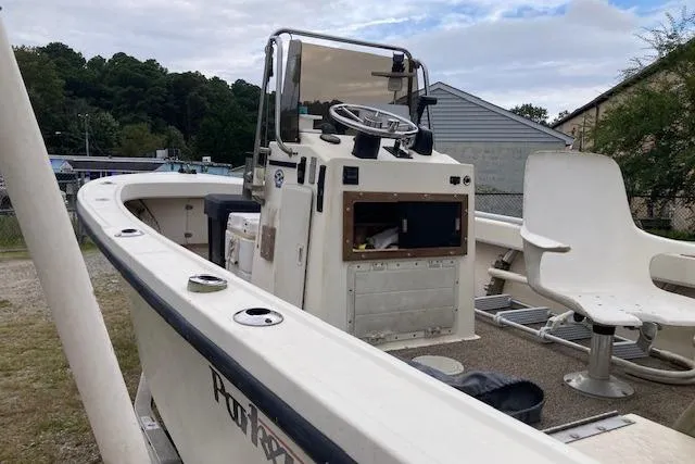 Slide: The Image of 1991 Parker 1801 Center Console boat with steering wheel and seating, docked outdoors. - 1