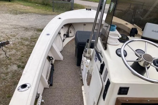 Slide: The Image of 1991 Parker 1801 Center Console boat interior with steering wheel and storage compartments. - 2