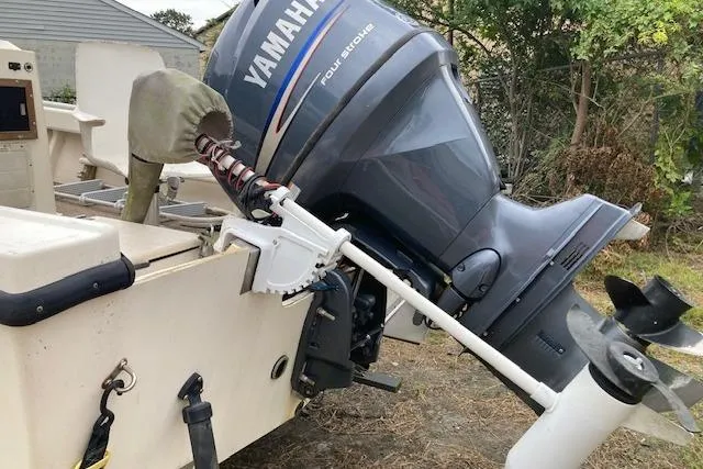 Slide: The Image of 1991 Parker 1801 Center Console boat with Yamaha outboard motor, parked on grass. - 7