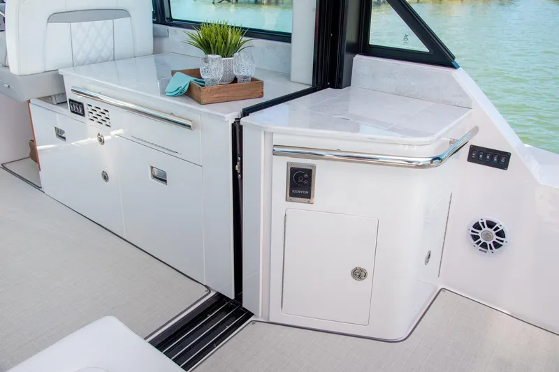 Slide: The Image of Interior of 2026 Regal 36 Grande Coupe yacht with sleek cabinetry and modern design. - 10