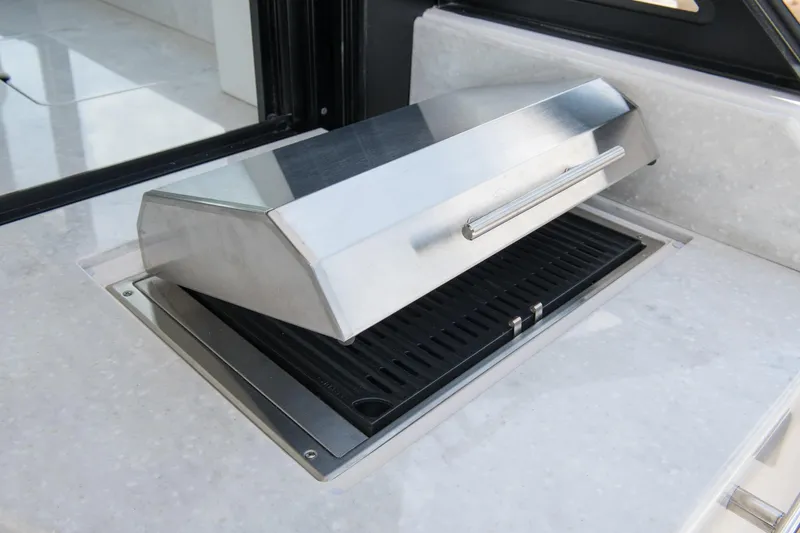 Slide: The Image of Built-in grill on 2026 Regal 36 Grande Coupe yacht's sleek countertop. - 11