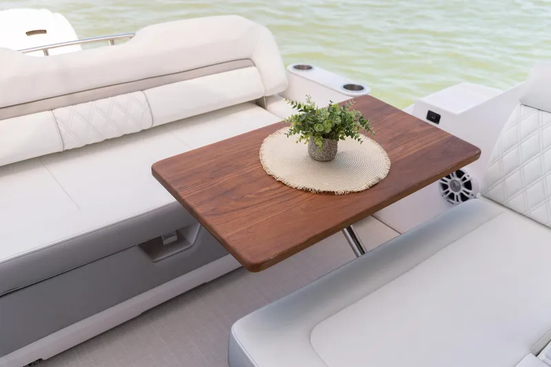 Slide: The Image of Luxurious seating area on 2026 Regal 36 Grande Coupe yacht with wooden table and plant. - 4