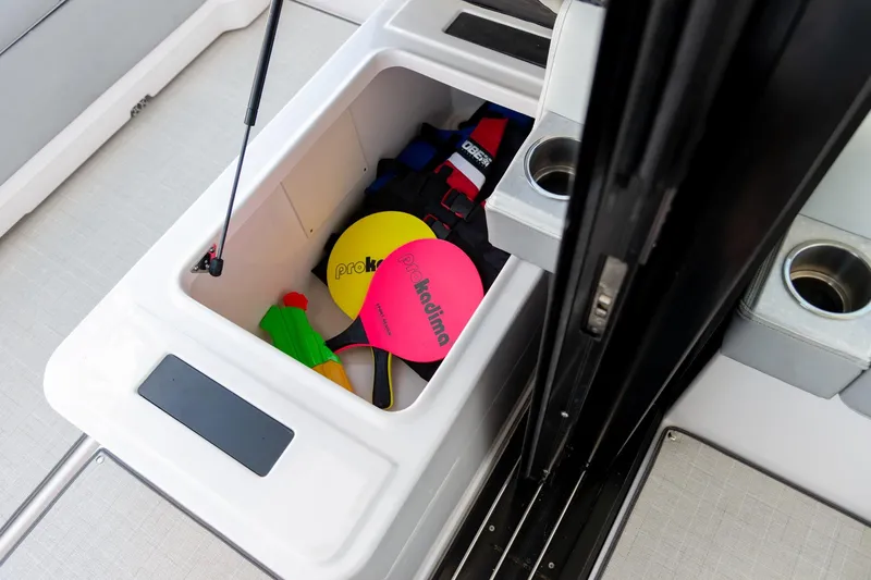 Slide: The Image of Storage compartment on 2026 Regal 36 Grande Coupe with life jackets and paddles. - 9