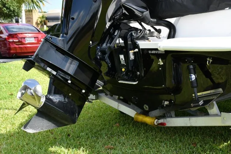 Slide: The Image of 2022 ALK2 Powerboats 18CRS motor detail on grass, showcasing engine and propeller. - 25