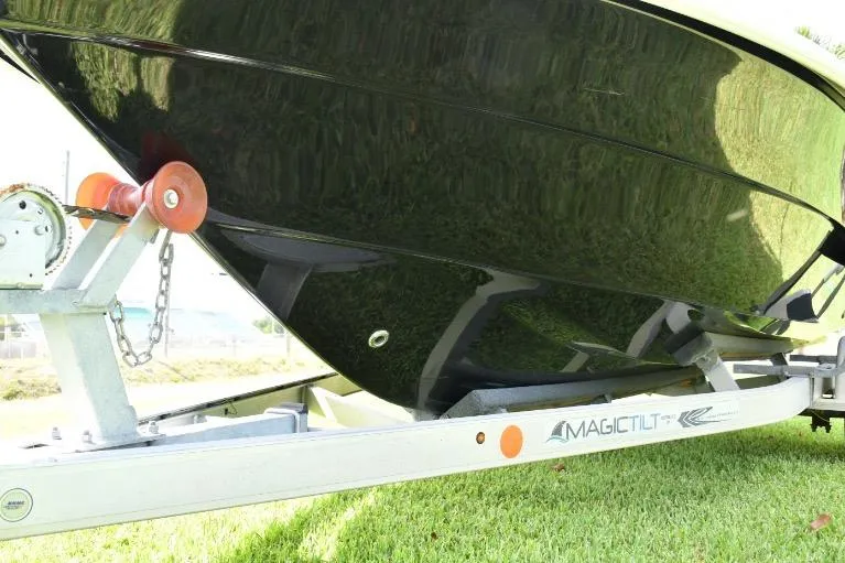 Slide: The Image of 2022 ALK2 Powerboats 18CRS on trailer, glossy black hull, grassy background. - 30