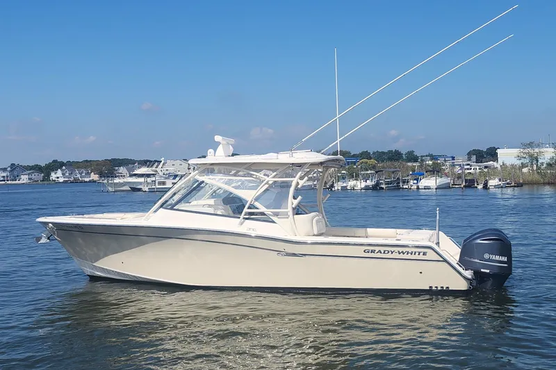 Slide: The Image of 2016 Grady-White Freedom 335 boat on calm water, clear sky background. - 0