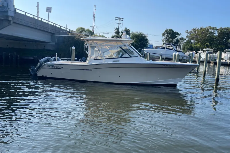 Slide: The Image of 2016 Grady-White Freedom 335 boat docked near a bridge in a marina. - 10