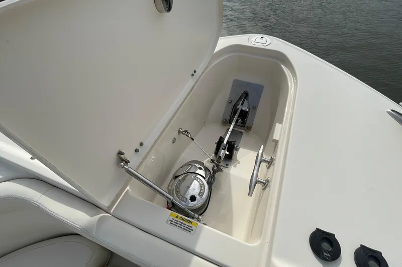 Slide: The Image of Anchor compartment of 2016 Grady-White Freedom 335 boat, open lid, showing anchor mechanism. - 12