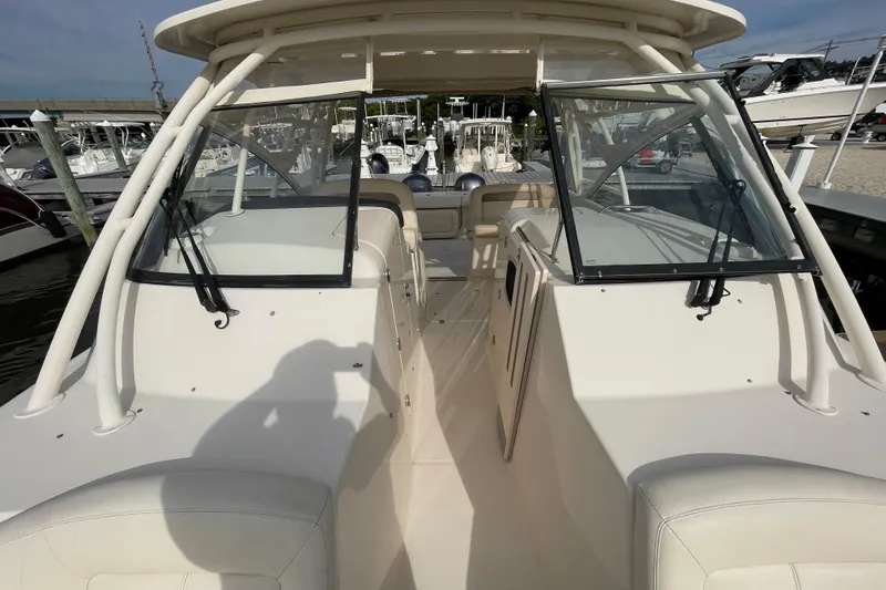 Slide: The Image of 2016 Grady-White Freedom 335 boat interior with open deck and seating at marina. - 17