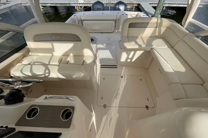 Slide: The Image of 2016 Grady-White Freedom 335 boat interior with beige seating and steering wheel. - 19